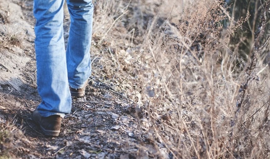 man walking on a trail