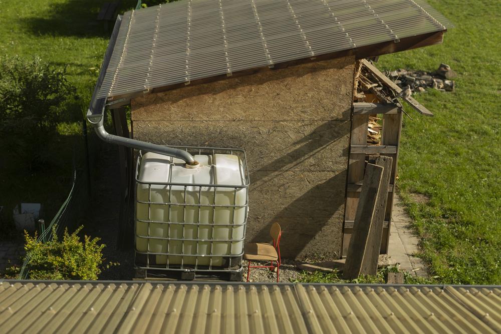 A sustainable water storage setup designed with solar panels and an IBC tank for efficient water management and landscaping