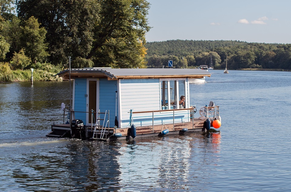 a blue houseboat on a lake