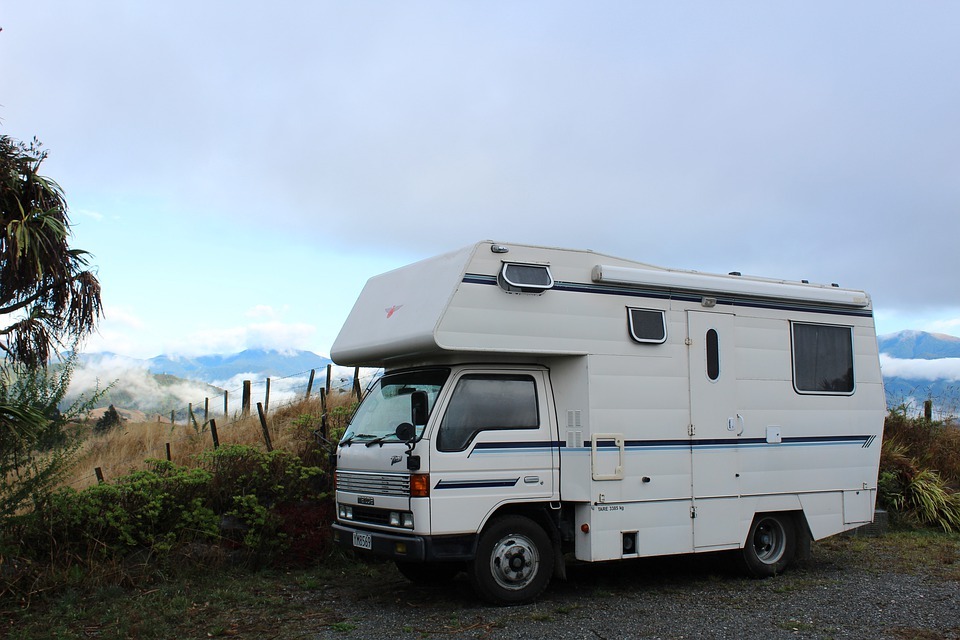 a large motorhome parked by the mountain